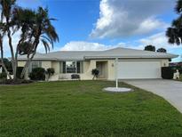 Well-maintained single story home featuring a 2 car garage, meticulous landscaping, and an idyllic garden at 465 Laurencin Dr, Nokomis, FL 34275