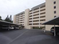 Low angle view of a condo building showing the parking area and the balconies at 512 W Venice Ave # 205, Venice, FL 34285