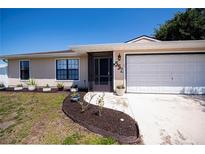 Charming single-story home featuring a well-manicured lawn and attached two car garage at 552 Bellaire Dr, Venice, FL 34293
