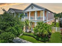 Charming two-story home with lush landscaping, inviting front porch and a second-story balcony at 12689 Sagewood Dr, Venice, FL 34293
