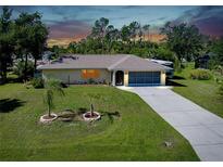 Charming single-story home with well-manicured lawn and extended driveway at 18375 Lamont Ave, Port Charlotte, FL 33948