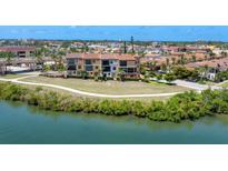 Luxury waterfront townhomes boasting tile roofs and lush landscaping at 209 E Venice Ave, Venice, FL 34285