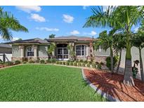 Charming single-story home with lush landscaping, stone accents, and a well-manicured lawn at 2769 Dode Ave, North Port, FL 34288