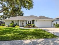 Charming one-story home with well-manicured lawn and colorful landscaping at 304 Rosewood Ct, Venice, FL 34293