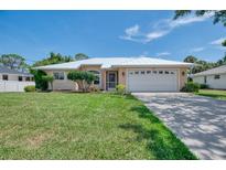 Charming single-story home featuring a well-manicured lawn, two-car garage and a durable metal roof at 331 Bucknell Rd, Venice, FL 34293