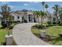 Beautiful home exterior featuring a circular driveway and lush landscaping at 333 Sunrise Dr, Nokomis, FL 34275