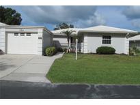 Charming single-story home with a well-manicured lawn, light grey paint, and white trim at 334 Dante Dr # 334, Nokomis, FL 34275