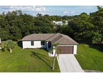 Lovely single Gathering home featuring an attached two car garage and mature landscaping in a peaceful setting at 3588 Erie Ct, North Port, FL 34287