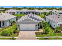 Charming single-story home with a two-car garage and beautifully landscaped front yard at 10367 Abaco Falls Dr, Englewood, FL 34223