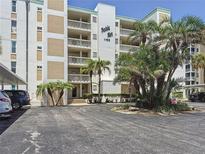Bahia Mar condo building with mature landscaping and covered parking area at 1100 Tarpon Center Dr # 503 5C, Venice, FL 34285