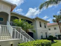 Beautiful condominium building showcasing manicured landscaping, white trim, and a private balcony at 1204 L Pavia Blvd # 1204, Venice, FL 34292