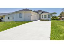 Charming one-story home with a pristine white exterior, a well-manicured lawn, and a long driveway at 1228 Pineland Ave, Venice, FL 34285
