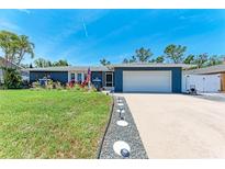 Charming single-story home with a well-manicured lawn and a two-car garage, perfect for suburban living at 5207 5Th Avenue Nw Dr, Bradenton, FL 34209