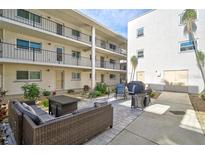 Beautiful community patio with comfortable seating and well-maintained landscaping at 708 Tamiami S Trl # 115, Venice, FL 34285