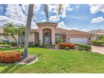 Charming single-story home featuring a tile roof, manicured landscaping, and a welcoming front entrance at 1345 Reserve Dr, Venice, FL 34285