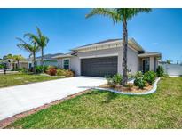 Well-maintained single-Gathering home with a two-car garage and lush landscaping at 137 Hercules Dr, Rotonda West, FL 33947
