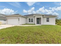 Beautiful single-story home with manicured lawn and a two-car garage at 137 Mariner Ln, Rotonda West, FL 33947