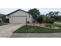 Charming single-story home with a well-manicured lawn and attached two-car garage at 14261 Palm Ter, Port Charlotte, FL 33953