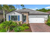 Beautiful one-story home featuring a paver driveway, stone accents, and a two-car garage at 20749 Swallowtail Ct, Venice, FL 34293
