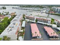 An aerial view of a waterfront condo building with boat docks, showcasing the property's location and parking at 250 Santa Maria St # 314, Venice, FL 34285