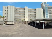 Exterior view of the building featuring ample parking and an architectural design at 333 The Esplanade N # 102, Venice, FL 34285