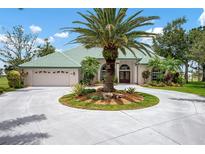 Beautiful single-story home featuring a circular driveway, well-manicured landscaping, and a tile roof at 467 Sherbrooke Ct, Venice, FL 34293