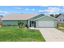 Charming single-story home with a well-manicured lawn, and a two-car garage at 5828 Lincoln Rd, Venice, FL 34293