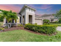 Charming single-Gathering home featuring a manicured lawn, tropical landscaping, and a stone-accented facade at 11240 Spring Gate Trl, Bradenton, FL 34211