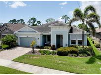 Charming single-story home with beautiful landscaping and a welcoming front porch swing at 11560 Tapestry Ln, Venice, FL 34293