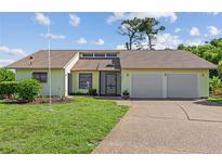Charming single-story home with a well-maintained lawn, two-car garage, and inviting entrance at 1315 Pine Needle Rd, Venice, FL 34285