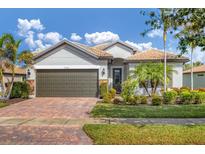 Charming single-story home with a tile roof, brick driveway, and well-maintained landscaping at 13334 Pacchio St, Venice, FL 34293