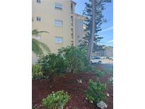 A beautiful view of the exterior of the building showing colorful plants and well maintained landscaping at 3697 Lake Bayshore Dr # H-109, Bradenton, FL 34205