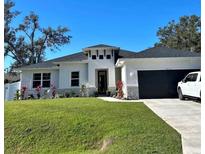 Charming single Gathering home featuring fresh landscaping and a two-car garage at 4033 Union Ln, North Port, FL 34288