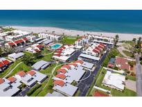Aerial view of a beachfront community with a pool, tennis court, and easy access to beach at 500 Park S Blvd # 33, Venice, FL 34285