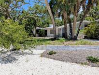 Charming single-story home nestled among lush trees and landscape, offering a serene coastal ambiance at 5369 Shadow Lawn Dr, Sarasota, FL 34242