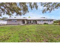 Charming single-story home featuring a metal roof, well-manicured lawn, and inviting curb appeal at 612 Bayshore Rd, Nokomis, FL 34275
