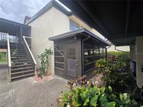 Charming condo exterior with a lovely screened in porch and mature landscaping around the property at 624 White Pine Tree Rd # 5, Venice, FL 34285