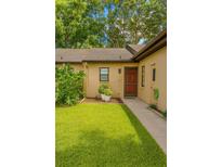 Inviting single-story home with a well-manicured lawn and charming front door entrance at 7201 Daiquiri Ln, Tampa, FL 33634