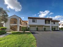 Inviting two-story condo featuring a private entrance and attached garages at 800 Capri Isles Blvd # 235, Venice, FL 34292