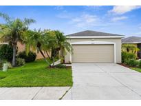 Charming single-Gathering home with a two-car garage, well-maintained lawn, and attractive landscaping at 11819 Tempest Harbor Loop, Venice, FL 34292