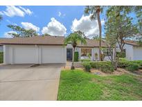 Charming single-story home with a well-manicured front yard, two-car garage, and inviting curb appeal at 1211 Capri Isles Blvd # 6, Venice, FL 34292