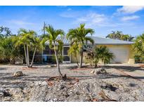 Charming single-story home featuring a metal roof, well-kept landscaping, and a lovely, serene curb appeal at 1350 Holiday Dr, Englewood, FL 34223