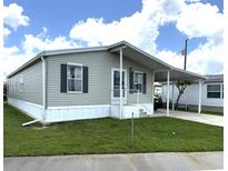 Charming single-story home featuring a carport and well-maintained lawn at 217 Blackburn Blvd, North Port, FL 34287