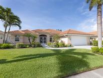 Charming single-story home with a well-manicured lawn and a tile roof in a sunny neighborhood at 346 Roseling Cir, Venice, FL 34293