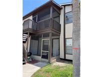 Two-story condo featuring a screened patio and balcony with dark brown trim and neutral-colored siding at 3862 59Th W Ave # 4180, Bradenton, FL 34210