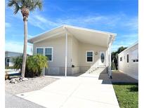 Charming single-story home featuring a covered parking area, well-maintained landscaping, and a welcoming entrance at 660 N Green Cir, Venice, FL 34285