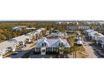 Scenic community featuring multiple buildings, a swimming pool, tennis court, parking, and lush landscaping at 6800 Placida Rd # 280, Englewood, FL 34224