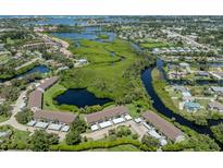 Beautiful aerial view of the community showcasing lush landscaping, waterways, and nearby amenities at 841 Waterside Dr # 202, Venice, FL 34285