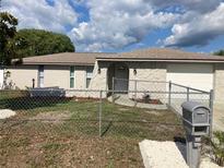 Charming single-story home featuring a decorative stone facade, fenced yard, and well-maintained landscaping at 9110 Lunar Ln, Port Richey, FL 34668