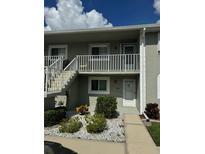Two-story condo building with updated exterior and landscaping at 3310 Loveland Blvd # 1406, Punta Gorda, FL 33980